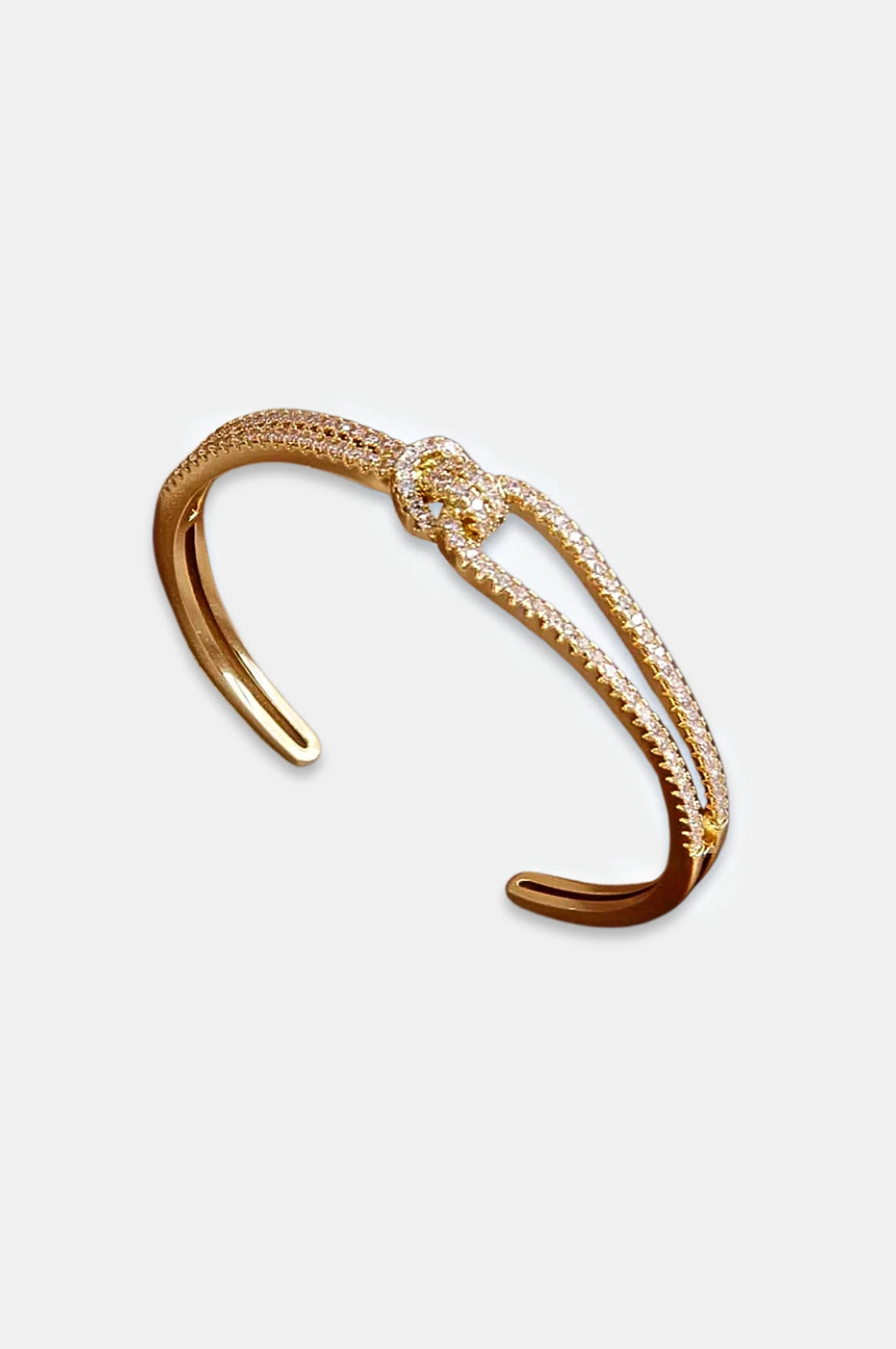 Gold knot bangle, elegant gold bracelet, sparkling bangle, high-quality stainless steel jewelry, luxurious bangle with stones, statement bracelet, stylish gold accessory, timeless jewelry design, La Lueure